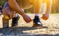 Close up cropped image of caucasian sportsman tying shoelaces Royalty Free Stock Photo