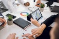 Close up cropped image of hands of diverse team of businesspeople, sitting at the table at office, and working with Royalty Free Stock Photo