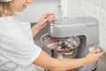 Close up cropped image of hands of woman confectioner, using food processor to kneading dough for desserts Royalty Free Stock Photo