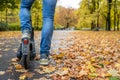 Close-up cropped image of a man on an electric scooter in Autumn Royalty Free Stock Photo