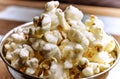 Close-up cropped image of popcorn over wood background