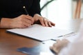 Close up cropped image young woman signing business agreement.