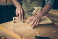 Close up cropped photo of handicraftsman`s hands sanding the sur Royalty Free Stock Photo