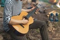 Close up cropped photo. hiker enjoying playing the instrument