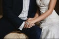 Close up cropped photo of male and female hands with expensive wedding rings. Male hands holding beautiful female hands Royalty Free Stock Photo