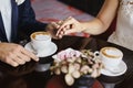 Close up cropped photo of male and female hands with expensive wedding rings. Male hands holding beautiful female hands Royalty Free Stock Photo