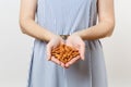 Close up cropped photo of woman hold in hands brown unprocessed almonds nuts isolated on white background. Proper Royalty Free Stock Photo