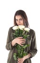 Close up cropped portrait of charming cheerful hispanic woman with natural makeup having bouquet of white roses in hands looking a Royalty Free Stock Photo