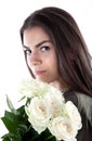 Close up cropped portrait of charming cheerful hispanic woman with natural makeup having bouquet of white roses in hands looking a