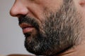 Close-up cropped portrait of a man with gray haired bristle or stubble. Mens beauty concept.