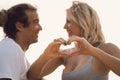 Close-up cropped portrait of nice couple in heart shape isolated