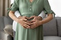 Close up cropped of pregnant woman with husband touching belly Royalty Free Stock Photo