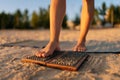 Close-up cropped shot of feet unrecognizable woman stepping on Sadhu Nail board during concentration meditation practice