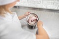 Close up cropped shot of female confectioner, making cream for cake or cookies macarons, mixing ingredients in the bowl