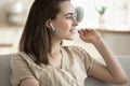 Girl listens favourite music using modern wireless earphones Royalty Free Stock Photo