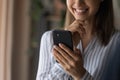 Smiling confident young female enjoy using modern smartphone device Royalty Free Stock Photo