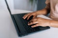 Close-up cropped shot of unrecognizable African-American freelancer in casual clothes working typing on laptop computer Royalty Free Stock Photo