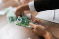 Close-up cropped shot of unrecognizable businessman in suit counting money at workplace sitting at desk. Successful Royalty Free Stock Photo