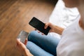 Close-up cropped shot of unrecognizable young woman buying online with credit card using mobile phone, doing online Royalty Free Stock Photo