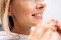 Close-up cropped shot of unrecognizable young woman patient holding invisible braces aligner during consultation at Royalty Free Stock Photo