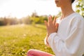 Close-up cropped shot of unrecognizable young woman practicing yoga doing Ardha Padmasana exercise and meditating in Royalty Free Stock Photo