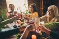 Close-up cropped view of hands clinking wineglasses juice nice attractive cheerful big full family meeting eating