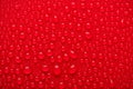 Close up cropped view photo image of shiny burgundy maroon bright color waterdrops on red background