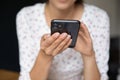 Close up cropped of woman holding smartphone, browsing apps Royalty Free Stock Photo