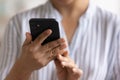 Close up cropped of young woman holding smartphone, using device Royalty Free Stock Photo