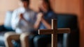 Close up cross is blur background. Asian Christian woman and man holding hands in praying for Jesus` blessings to show love and Royalty Free Stock Photo