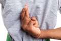 Close-up crossed fingers of supermarket employee