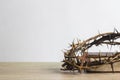 Close up of crown of thorns of Jesus on top of the holy bible on wooden table