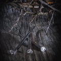 Close up crown of thorns and nails again vintage wooden background as symbol of crucifixion of Jesus Christ