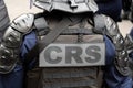 Close-up 'CRS' (riot police) marking written on the back of a tactical vest, Paris, France