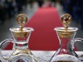 Close up of cruets with water and wine ready for catholic mass with red carpet and people in the background Royalty Free Stock Photo