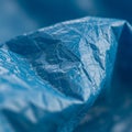 Close-up of a crumpled blue plastic sheet. The texture is rough and wrinkled, with Royalty Free Stock Photo