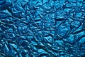 Close-up of crumpled silver aluminum foil texture in blue tone. Abstract background for design. Royalty Free Stock Photo