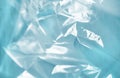 Close-up of crumpled translucent blue plastic with light reflections, creating an abstract and modern background Royalty Free Stock Photo