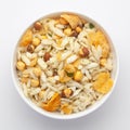 Close-Up of Crunchy Diet Mixture in a white Ceramic bowl made with Puffed Rice, Corn Flakes, and Curry leaves. Indian spicy snacks Royalty Free Stock Photo