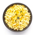 Close-Up of Crunchy Murmura in a black Ceramic bowl, made with Puffed Rice and Curry leaves. Indian spicy snacks Namkeen,