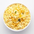 Close-Up of Crunchy Murmura in a white Ceramic bowl, made with Puffed Rice and Curry leaves. Indian spicy snacks Namkeen,