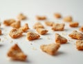 Close up of crunchy pretzel pieces scattered on white background. Broken salty cracker bits with crumbs create textured pattern. Royalty Free Stock Photo