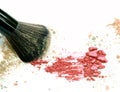 Close up of crushed blush on white background and cosmetic brush. Royalty Free Stock Photo