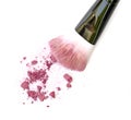 Close up of crushed blush on white background and cosmetic brush. Royalty Free Stock Photo