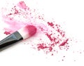 Close up of crushed blush on white background and cosmetic brush. Royalty Free Stock Photo