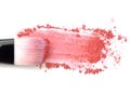 Close up of crushed blush on white background and cosmetic brush. Royalty Free Stock Photo