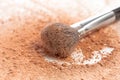 Close-up of crushed mineral shimmer powder golden color with makeup brush Royalty Free Stock Photo