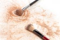 Close-up of crushed mineral shimmer powder golden color with makeup brush Royalty Free Stock Photo