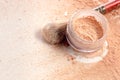 Close-up of crushed mineral shimmer powder golden color with makeup brush Royalty Free Stock Photo