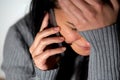 Close up of crying woman calling on smartphone